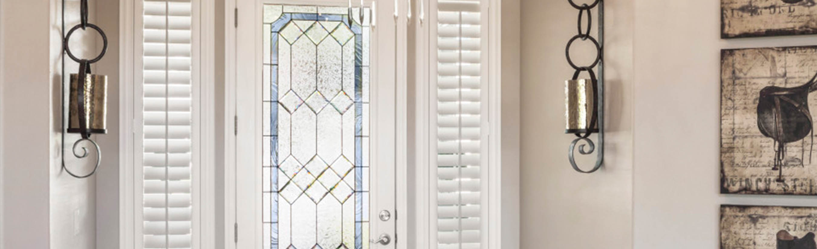 White sidelights on each side of the entrance door in a foyer.