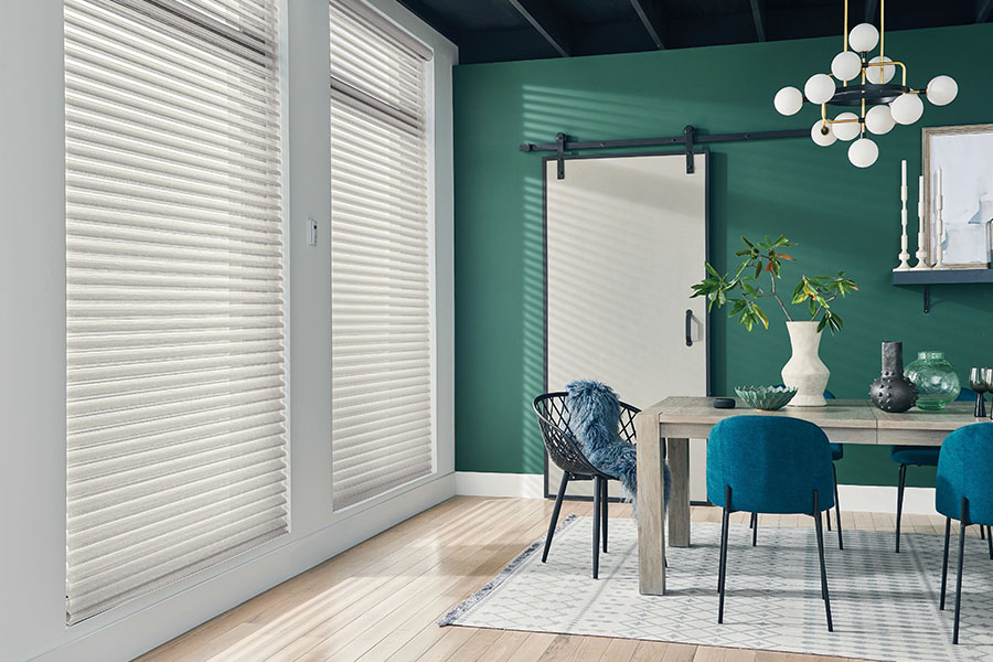 White sheer shades on windows in a green dining room