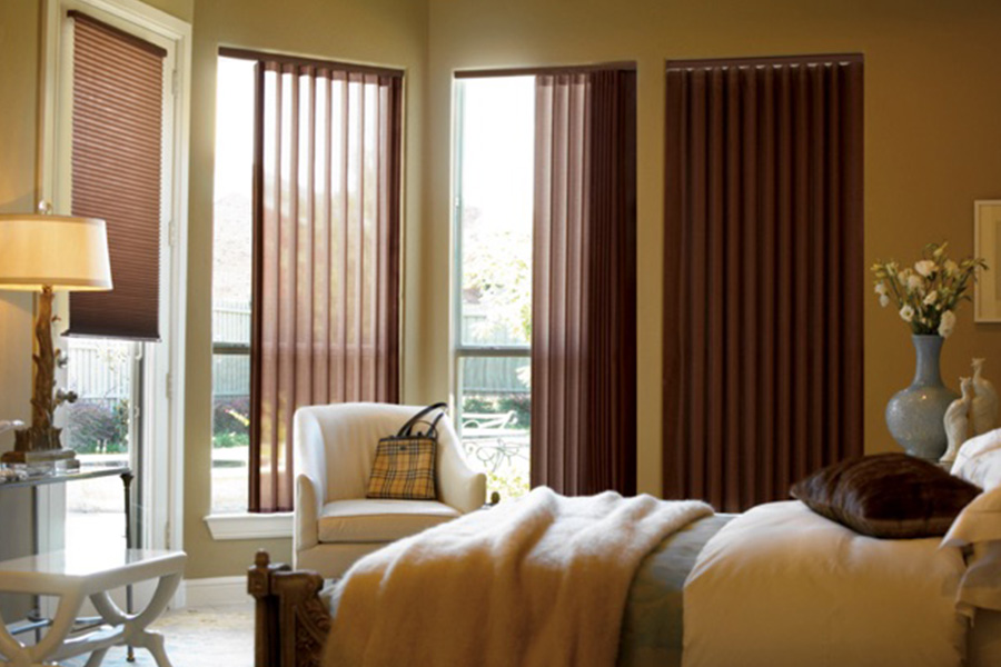 Choose durable and high-quality fabric or vinyl vertical blinds in Fort Myers. Maroon fabric vertical blinds inside a bedroom
